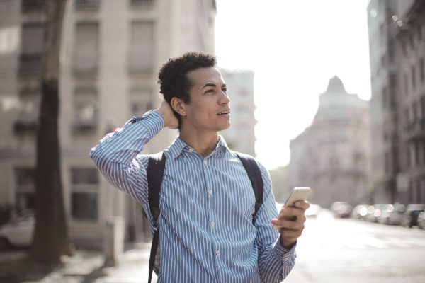 A man standing in the street looking confused.