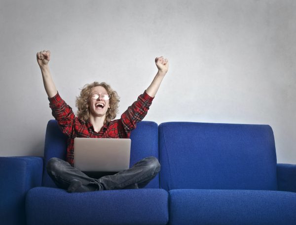 Woman Celebrating on Couch