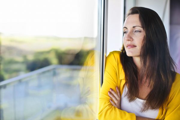 Woman looking out window