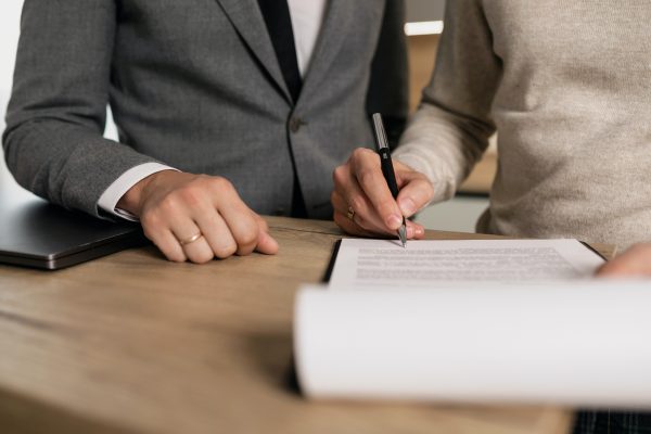 Woman signing contract for house.